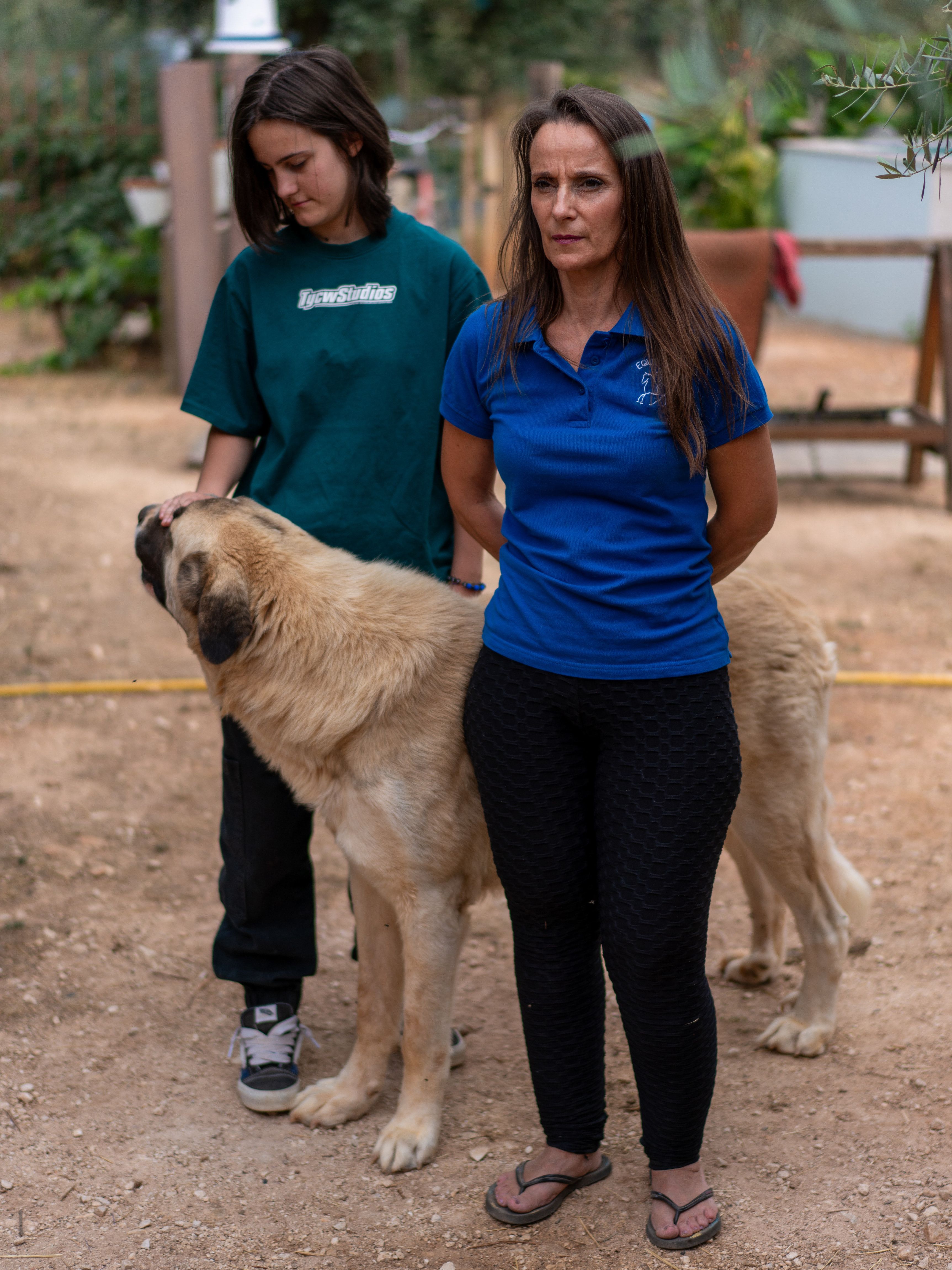 Two women accompany a dog in the Quinta's outdoor grounds.